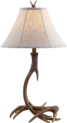 the antler lamp has a white shade on it