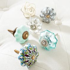 an assortment of decorative knobs on a white surface