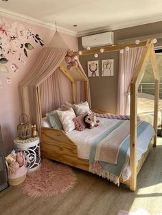 a bedroom with a canopy bed and pink walls