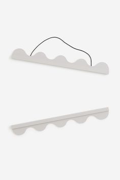 two white plastic hangers on a wall