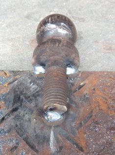 an elephant statue on the ground with its trunk sticking out