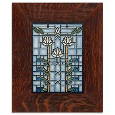 a stained glass window in a wooden frame with flowers on it and green leaves around the edges