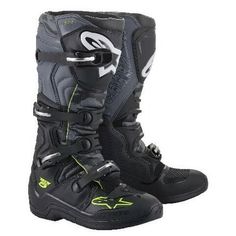 a pair of black and green motorcycle boots