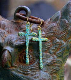 Rustic hammered brass crosses, washed with a turquoise patina, sway long & lovely from simple brass ear wires...So Bohemian Chic! Uniquely hand crafted with these quality materials: ~ Hammered brass cross charms with turquoise patina, washed with non-toxic acrylic paint & sealed with Renaissance Wax ~ Antiqued brass lead & nickel-free French style ear wires ~ Silicone earring backs to keep earrings securely in ears Measuring 2-1/4 inches from the top of the ear wires to the bottom of Bohemian Cross Shaped Brass Jewelry, Bohemian Brass Cross Jewelry, Bohemian Style Brass Cross Jewelry, Bohemian Turquoise Hammered Earrings, Bohemian Blue Hammered Earrings, Blue Bohemian Hammered Earrings, Hippie Chic Jewelry, In Ears, Boho Cross