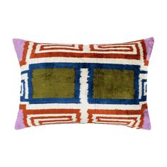 an orange and blue pillow with squares on it, sitting on top of a white surface