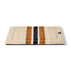 a dog bed that is made out of wool and has an orange stripe on the front