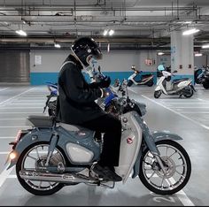 a man riding on the back of a motorcycle in a parking garage