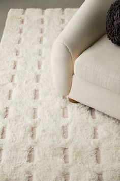 a white chair sitting on top of a rug