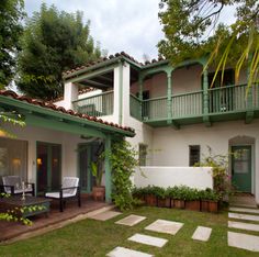 a white and green house with steps leading up to it