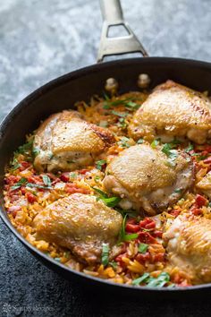 chicken and rice in a skillet with a spatula on the side, ready to be eaten