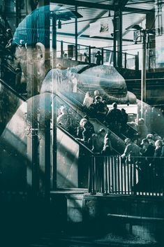 people are standing on an escalator in a building