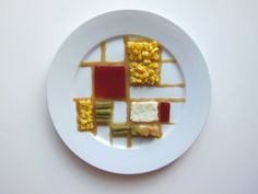 a white plate topped with different types of food on top of a white tablecloth