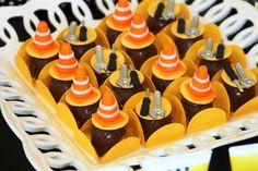 there are many chocolates with orange cones on them in the tray for desserting