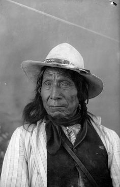 an old black and white photo of a woman wearing a hat with her eyes wide open