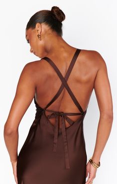 the back of a woman wearing a brown dress