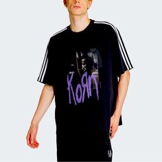 This Limited Edition T-Shirt Features A Collaboration Between The Iconic Rock Band Korn And Sportswear Brand Adidas. The Black Shirt With The Adidas Park Logo And The Korn Signature Is A Must-Have For Any Fan Of The Band Or Sports Fashion. It Comes In Size Large And Is Perfect For Anyone Who Has Love For Athletic Wear With A Touch Of Rock And Roll. The T-Shirt Is A Collector's Item For Music Enthusiasts. The Shirt Is Brand New And Sealed, Making It An Excellent Gift For Yourself Or Someone Speci Urban Purple Short Sleeve T-shirt, Purple Relaxed Fit T-shirt For Streetwear, Sporty Purple Tops With Graphic Print, Purple Graphic Print Top For Streetwear, Sporty Purple T-shirt With Graphic Print, Purple Graphic Tee Tops For Streetwear, Purple Graphic Crew Neck Top, Adidas Urban T-shirt With Graphic Print, Adidas Urban T-shirt For Streetwear