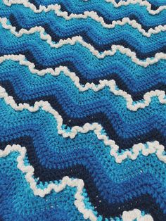 blue and white crocheted blanket with wavy waves