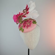 THIS ONE IS MADE TO ORDER IN YOUR CHOICE OF COLORS FOR BASE AND FEATHERS, EMBROIDERED PART WILL BE THE SAME COLOR ☀ Follow this link for more beautiful choices from 'Indigo Hats'  https://www.etsy.com/shop/IndigoHats ☀ I love the drama of this hat!  I handblocked layers of light pink straw in a flattering button shape.  Then added a stunning embroidered floral lace design in pink and gold with a lively flourish to follow the lines of the hat.   Matching hand tied exuberant ombre feathers  around Handmade Fitted Hats For Formal Occasions, Handmade Fitted Formal Hats, Formal Fitted Handmade Hats, Handmade Fitted Fascinator For Party, Handmade Evening Headpiece For Kentucky Derby, Handmade Mini Hat For Kentucky Derby Evening, Fitted Evening Hat With Pinched Crown, Handmade Fascinator For Kentucky Derby Party, Handmade Fascinator For Kentucky Derby Evening