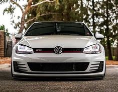 the front end of a white volkswagen golf