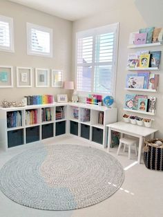 a white room with bookshelves and toys on the floor