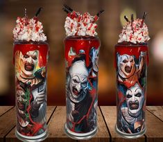 three cans with clowns on them sitting on a table