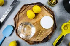 lemons and other kitchen utensils on a cutting board