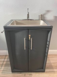 a bathroom sink sitting on top of a wooden floor