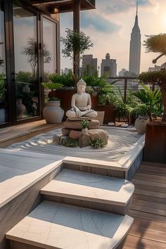 a buddha statue sitting on top of a wooden deck next to plants and potted trees