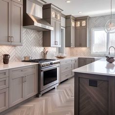 a kitchen with gray cabinets and white counter tops