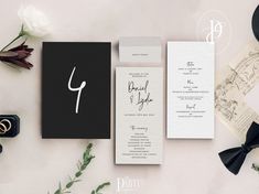 the wedding stationery is laid out on top of each other