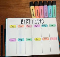 an open planner with markers and pens on it