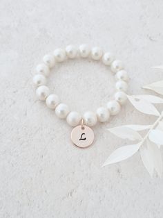 This sweet little pearl bracelet is personalised pearl to suit your bridal party. This bridal bracelet is made from 8mm glass pearls and 12mm rose gold plated initial disc. Your jewellery will arrive in a gift box ready for giving. This item ships from the UK within 1 working day. Please see size guide below: Sizes for children 3-6 months    4.25-4.5in 6-12 months    4.75in 12-24 months    5in 2-3 years    5.0-5.5in 4-5 years    5.75in 6-8 years    6in 9-13 years    6.25in Adult Sizes Small Elegant Personalized Round Bead Pearl Bracelet, Personalized Elegant Pearl Bracelet, Elegant Personalized Pearl Bracelet, Elegant Pearl Bracelet With Letter Beads, Personalized Round Bead Pearl Bracelet In Elegant Style, Personalized Round Bead Pearl Bracelet, Adjustable Pearl Charm Bracelet For Wedding, Elegant Personalized Rose Gold Beaded Bracelets, Elegant Personalized Rose Gold Beaded Bracelet