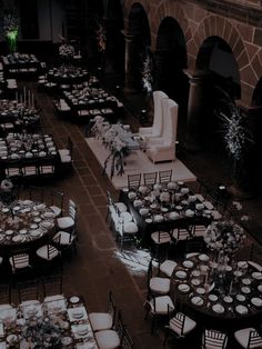 an overhead view of tables and chairs with white linens set up for a formal function