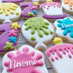 decorated cookies with the words smile time and noomi written on them are sitting on a table