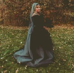 Bride with tattoos in an off-shoulder black wedding dress. She is outside in the fall. Black Plus Size Wedding Dress, Tattooed Bride, Brides With Tattoos