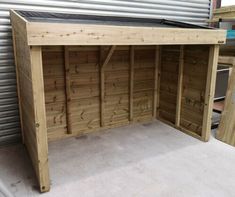 a wooden shed with the roof open