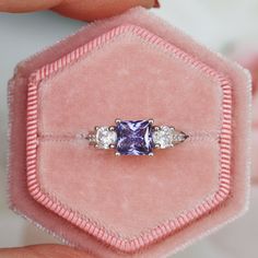 Gorgeous Princess Tanzanite Ring ►Made of sterling silver, rhodium plated (S925) ►Center stone: Tanzanite Color: Purple Gemstone Creation: Simulated Cut: Princess Gem size: 6.0 mm Carat Weight: 1.2 ct. (approx.) ►Accented with simulated diamonds (CZ) Cut: Round Gem size: 1.0 mm- 4.0 mm Color: Colorless ►Bands width: 2.4 mm ✓ 100% Nickel-Free ✓ Hypoallergenic ✓ Comfort Fit ✓ Free Ring Box ✓ Free USA Shipping ✓ Ready to ship next business day Wedding Sapphire Ring With Three Stones In Radiant Cut, Princess Cut Jewelry With Accent Stones For Proposal, Three Stone Round Cut Jewelry For Proposal, Three Stone Ring For Proposal, Classic Amethyst Promise Ring With Center Stone, Three-stone Fine Jewelry For Proposal, Fine Jewelry Three Stone For Proposal, Three Stone Fine Jewelry For Proposal, Classic Amethyst Ring With Cubic Zirconia For Wedding