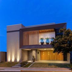 a modern house is lit up at night