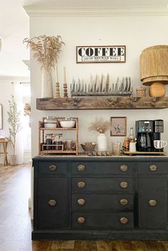 a coffee bar with lots of plates and cups on the top shelf, along with other items