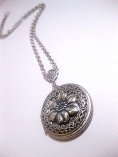 Silver Flower Locket The Locket: - Centered with a real flower in resin dome - Measures 32mm round (1.25 inches round) The connector and locket together hangs down approximately 2 inches from necklace chain. Chain: - Silver Plated - YOU CHOOSE YOUR CHAIN LENGTH FROM DROP DOWN MENU TOOL ☻☻ TO see MORE of our LOCKET NECKLACEs (while supplies last): https://www.etsy.com/shop/FashionCrashJewelry/search?search_query=locket&order=date_desc&view_type=gallery&ref=shop_search ☻ Link To My Ent Vintage Metal Flower Necklace As Gift, Vintage Metal Flower Necklace For Gift, Vintage Metal Flower Necklace Gift, Elegant Adjustable Round Flower Necklace, Vintage Circle Necklace For Gifting, Vintage Circle Necklace For Gifts, Adjustable Vintage Flower Shaped Jewelry, Vintage Flower-shaped Nickel-free Necklaces, Adjustable Round Flower Charm Necklace