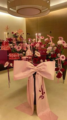 a table topped with lots of pink flowers and candles