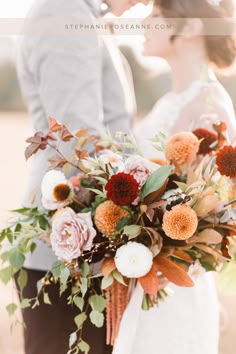 the bride and groom are holding their bouquets