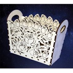 a laser cut box with roses on it