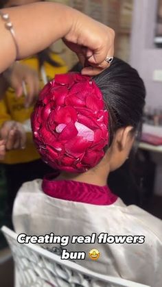 the woman is getting her hair done at the barbershop with flowers in it