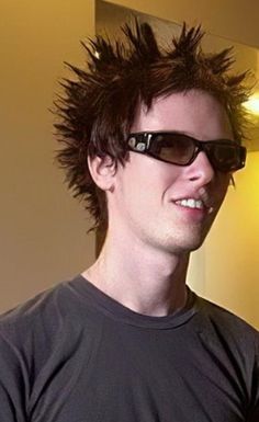 a young man with spiked hair and sunglasses