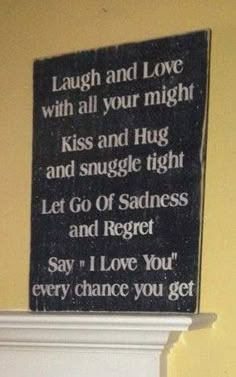 a sign that says laugh and love with all your might kiss and hug and smile tight