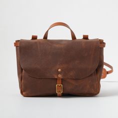 The leather messenger bag is an heirloom-quality bag that's up for any and every kind of work day: Whether you're headed to school, the office, or the field, this bag is ready. The messenger bag is a special-order item made in your choice of Kodiak, Cypress, or Horween leather. Its trim and strap can be made either with your choice of belting-weight leather or in the same leather as the body of the bag. Leather Satchel Flap Bag For On-the-go, Timeless Satchel Saddle Bag For Everyday, Timeless Saddle Shoulder Bag For Everyday, Timeless Shoulder Saddle Bag For Everyday Use, Timeless Brown Flap Bag For Everyday Use, Timeless Leather Satchel With Adjustable Strap, Timeless Everyday Satchel Flap Bag, Everyday Timeless Satchel Flap Bag, On-the-go Waxed Finish Shoulder Satchel