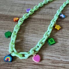 This lucky charms necklace will spread the luck of the Irish on Paddy's and year round. Each necklace will be uniquely handmade with a set of (8) lucky charms made out of acrylic. Share one with the little lucky charm in your life. The charms are fastened to plastic chain links, and finished off with a gold-plated lobster clasp. Each necklace will measure ~18". There will be variations in charms and colors due to the handmade nature and what's in stock, but send requests our way, and we'll do ou Green Dangle Charm Necklaces, Green Dangle Charm Necklace, Cute Handmade Plastic Necklace, Green Good Luck Charms Necklace, Playful Green Plastic Jewelry, Green Fun Plastic Jewelry, Fun Green Plastic Jewelry, Green Charm Necklaces With Chain As A Gift, Green Chain Charm Necklaces As Gift