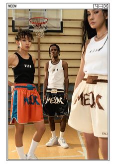 three young men standing in front of a basketball hoop