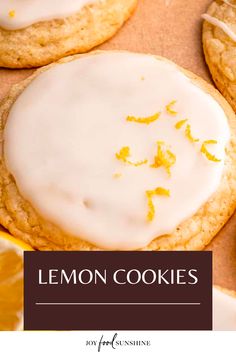 lemon cookies with white icing and oranges on the side, next to an orange slice